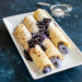 Steel crepe pan with golden blueberry crepes