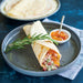 Savory ham and cheese crepe on a white plate