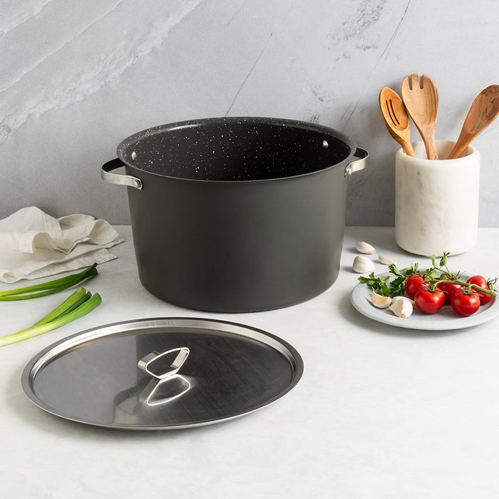 Verde 16 qt stock pot with lid styled with fresh tomatoes and wooden utensils