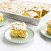 Naturals Big Batch Pan with a golden sheet cake and plated squares
