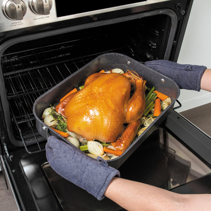 Pulling the Verde Grand Roaster with a roast turkey and vegetables out of the oven