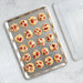 Big sheet pan with clear lid holding baked cookies