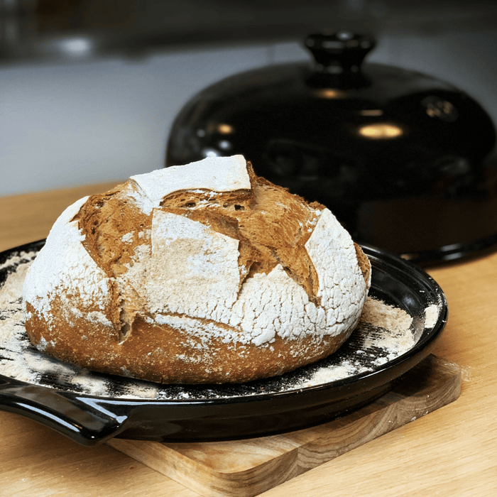 Emile Henry Bread Cloche in Charcoal — lifestyle, loaf of bread baking