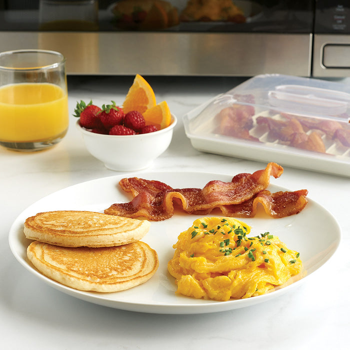 Compact bacon tray with cooked bacon beside a breakfast plate