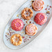 Glazed floral cakelets styled on concrete