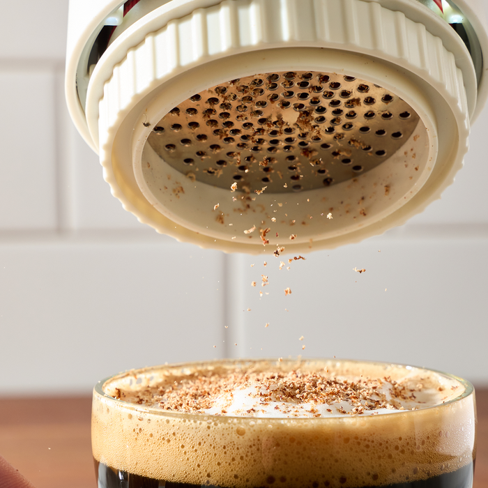 FinaMill Grater Pod dusting spice over a latte